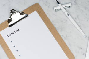 Prancheta com um checklist e uma caneta ao lado, para anotações de como aumentar as vendas.